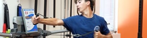 Male athlete performs a punching strength exercise.