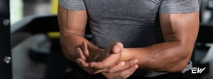Man holding his wrist due to hand or wrist pain.