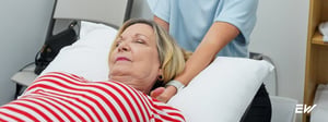 Physical therapist performing gentle manual therapy for cervical strain and neck pain relief in a clinical setting.
