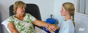 Therapist providing manual therapy to the wrist and thumb for De Quervain’s tenosynovitis.