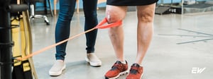 Individual performing resistance band exercise to rehabilitate the knee following a meniscus tear.”