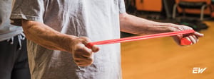Resistance band training for a patient with Parkinson’s disease to improve upper-body strength and movement control.