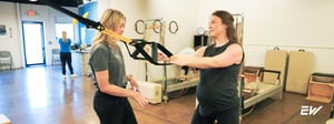 Woman performing supervised therapeutic exercise for pubic symphysis disorder during physical therapy.