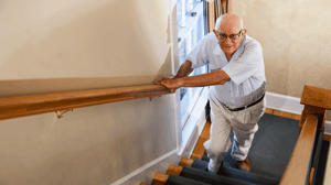 A senior man walks up the stairs.