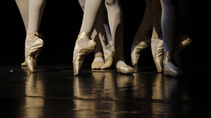 Close-up of ballerinas' feet en pointe.