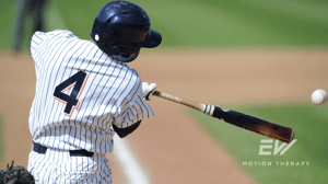 A baseball player takes a swing.