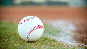 A close-up of a baseball sitting on the field.