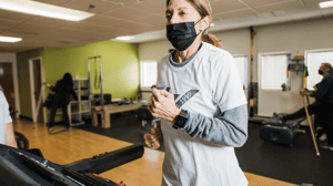 A woman jogs on a treadmill. 