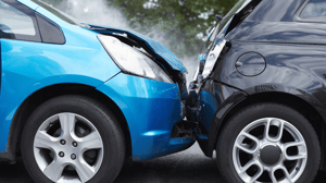 A blue car rear-ended a black car.