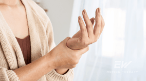 A woman grips her wrist in pain.