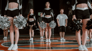 A group of cheerleaders stand ready to cheer.
