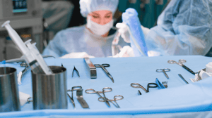 A surgical team and a tray of equipment