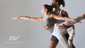 A male dancer lifts a female dancer.