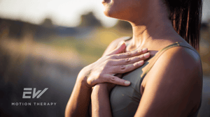 A woman puts both hands on her chest to take a deep breath.