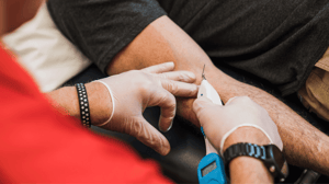 A man dry needles another man's arm.