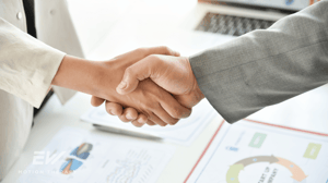 Two businessmen shake hands.
