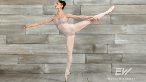 A dancer stands in arabesque.