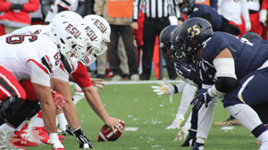 Football players get in formation for a play.