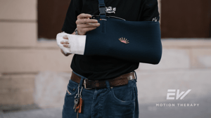 A man keeps his arm in a sling.