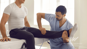 A physical therapist stretches a man's knee.