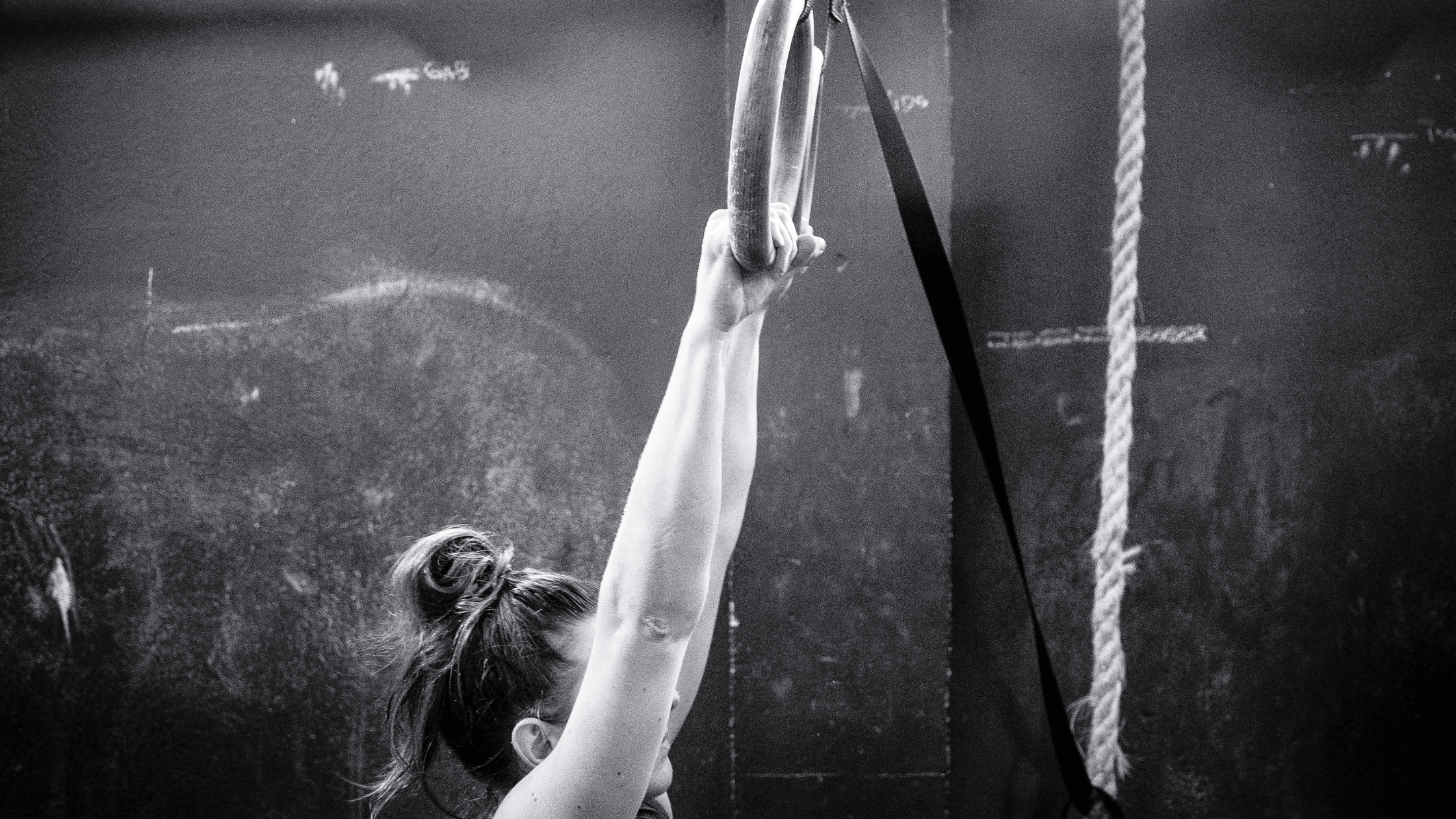 A gymnast holds on to a ring.