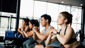 A group of people working out in a HIIT class.