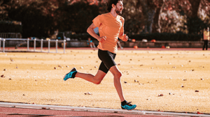 A man runs on a track.