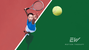 A tennis player throws up a ball for a serve.