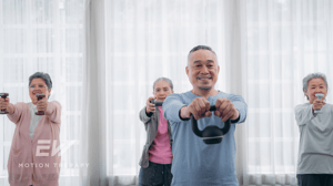 A group of older adults lift weights together.