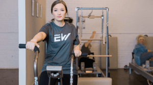 A woman pedals on an exercise bike. 