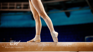 A gymnast's feet balance on a beam.