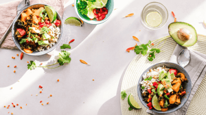 Two plates of colorful, healthy food.