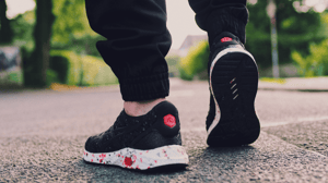 Feet walking away from the mid-calf down.