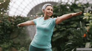 An older woman practices a yoga pose.