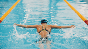 A swimmer does a breaststroke.