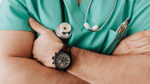 A close-up of a man in scrubs.