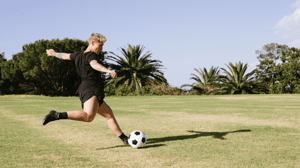 A soccer player winds up for a kick.