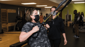 A woman pulls resistance bands.