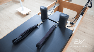 From above, a Pilates reformer in a studio.