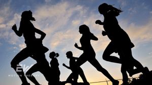 A group of runners in silhouette.