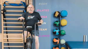 A man rides an exercise bike. 