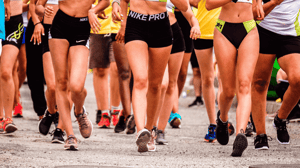 A group of runners from the waist down.