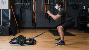 A man drags a weight around his waist.