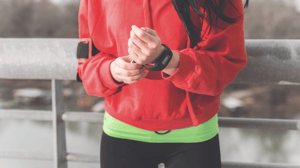 A woman adjusts the pedometer on her wrist.