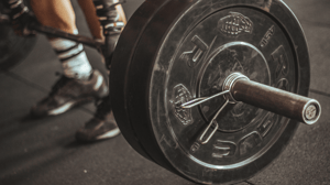 A man lifts a barbell.