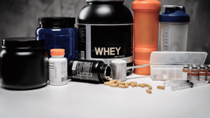 An array of supplements, including whey protein and other powders.