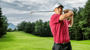 A guy swinging a golf club