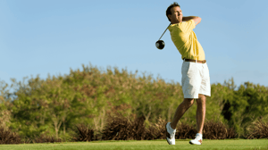 A golfer goes for a long shot.
