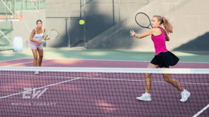 Two tennis players running on the court.