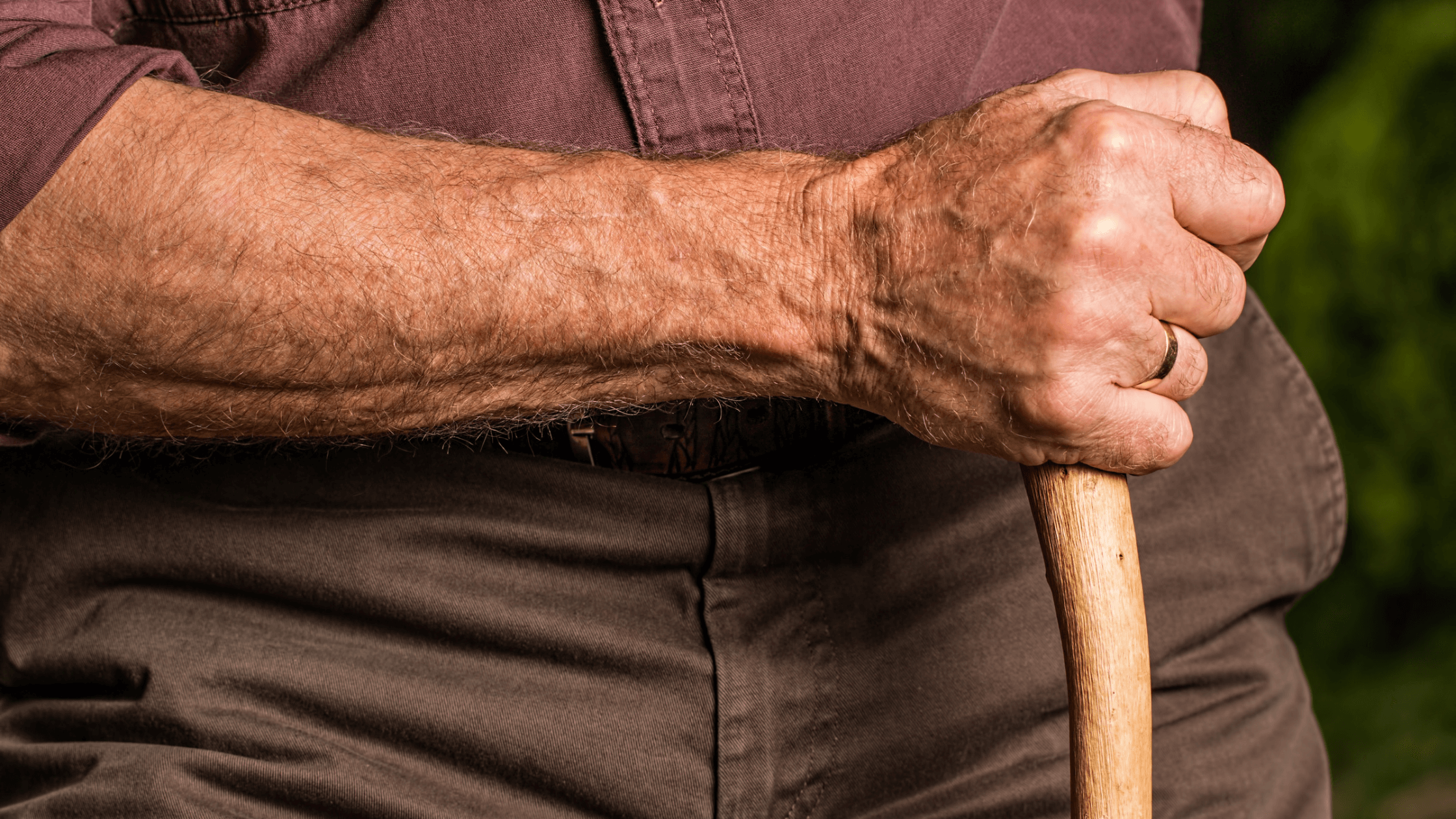 An old man holds a cane